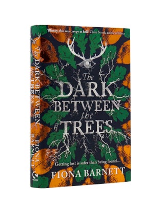 Item #2042 The Dark Between The Trees. Fiona Barnett